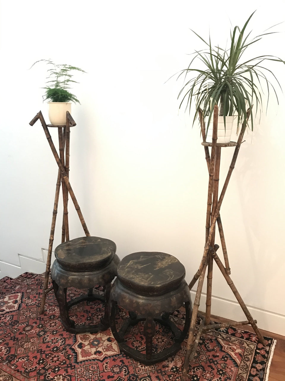 Antique Chinese lacquered stools beside a pair of Aesthetic Movement Victorian bamboo jardinieres 